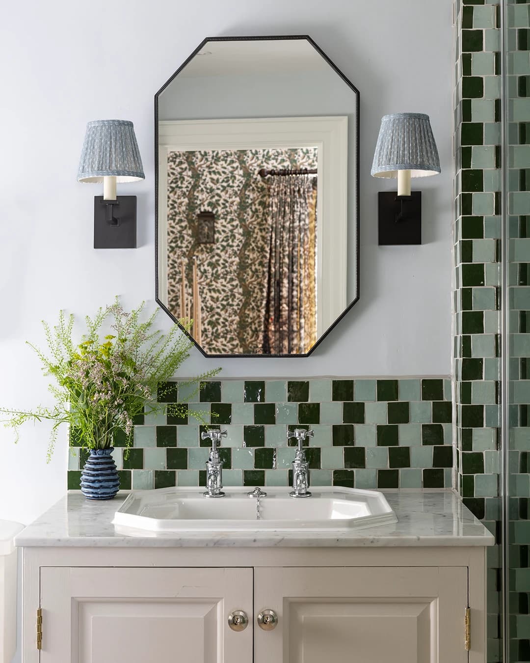 Bathroom and shower in Zellige, with two colours laid in an irregular checkerboard pattern.