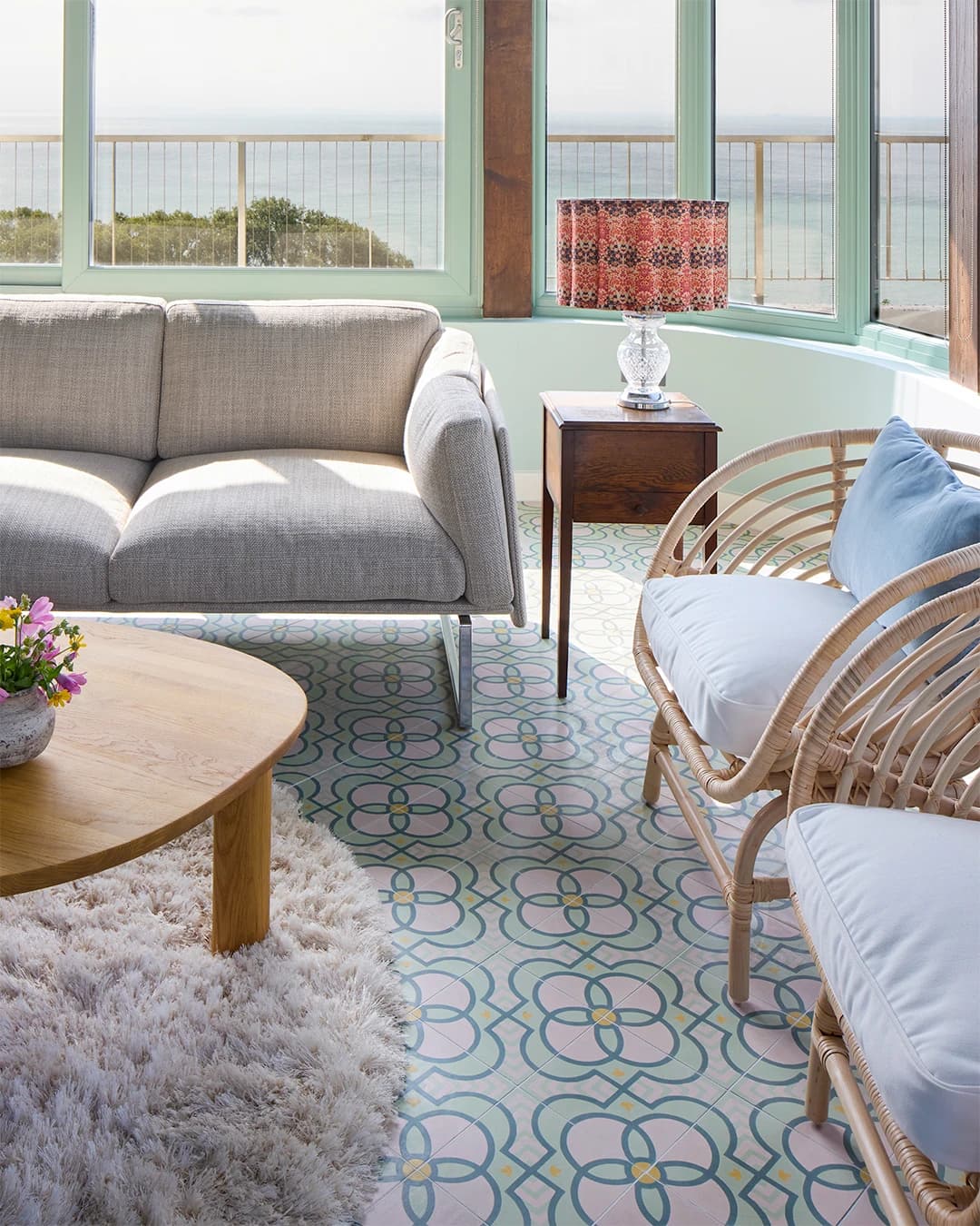 Veranda floor in cement tiles in soft pastel shades.